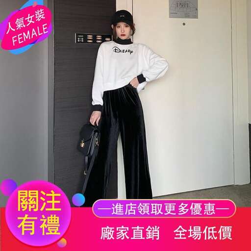 a woman in a white shirt and black pants standing in a room.