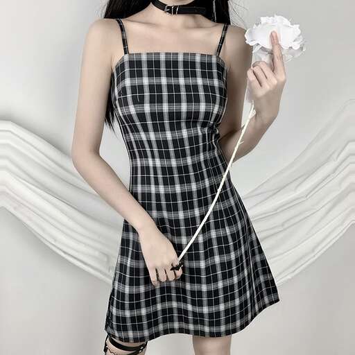 a woman in a plaid dress holding a flower.