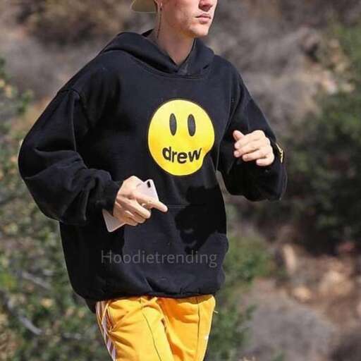 a man in a hat and sweatpants running with a smiley face.