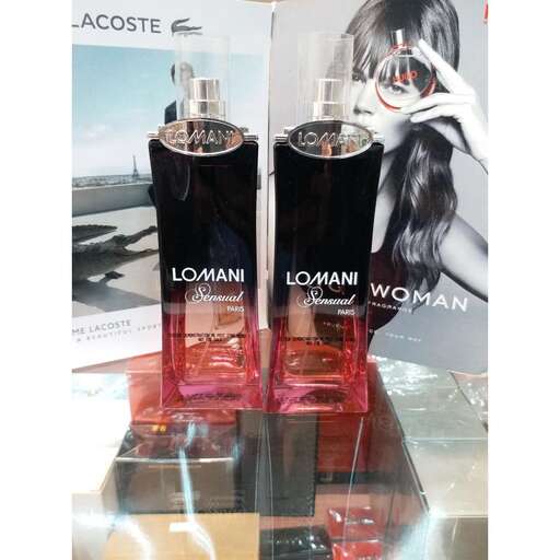 a woman is standing next to a bottle of perfume.