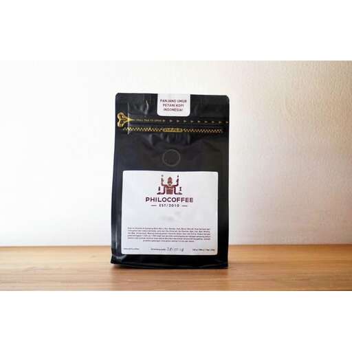 a black coffee pot with a label on it.