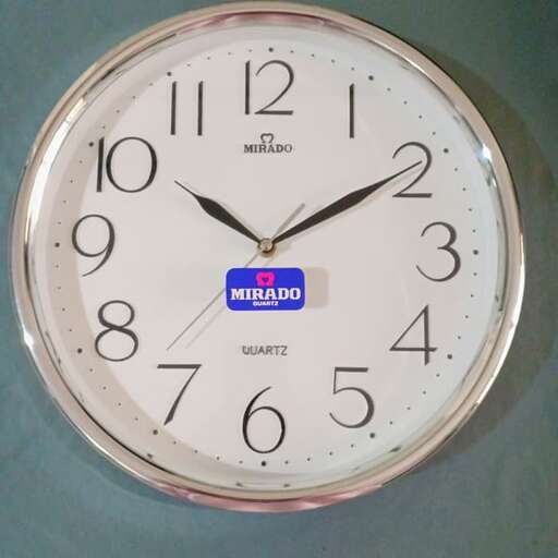 a clock with a blue label on it.