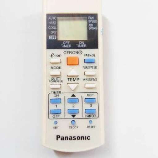 a large white remote control with blue buttons.