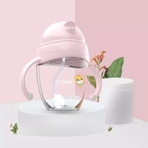 a pink glass fish tank with a bird inside.
