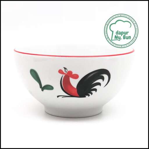 a bowl of chicken in red and white.