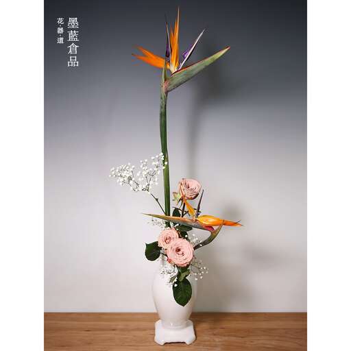 a large white vase with flowers in it.