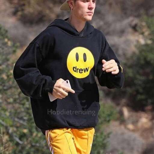 a man in a hat and sweatpants running.
