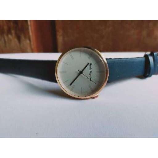 a watch with a blue strap.