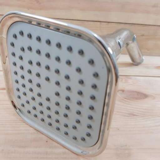 a shower head with a metal handle.