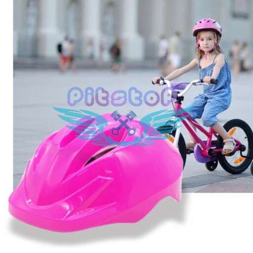 a girl riding a pink bicycle with a pink buggy on the front.