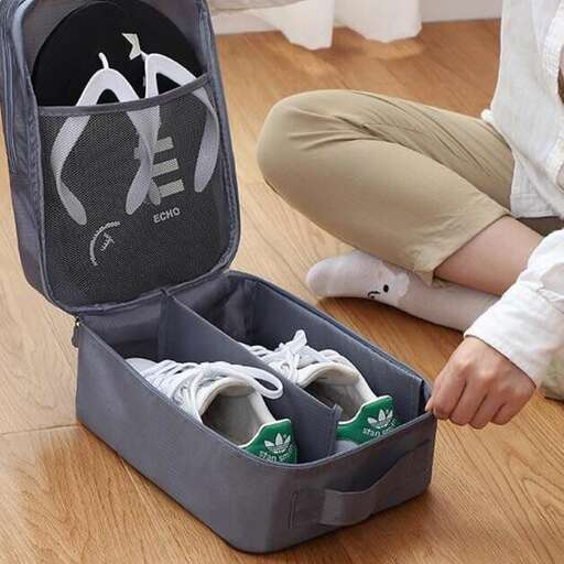 a person is opening a suitcase with a pair of shoes.