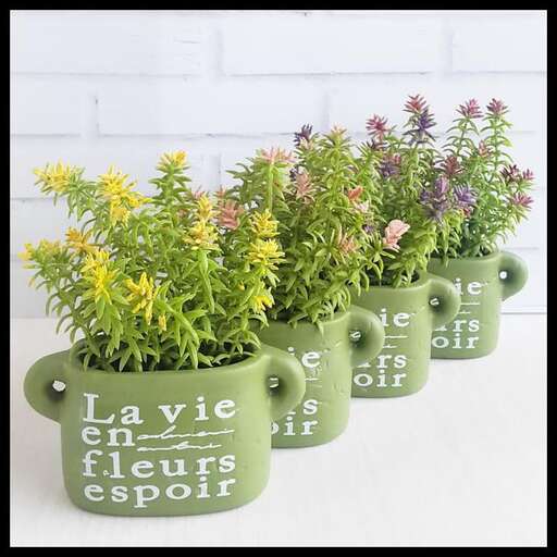 a row of flower pots with flowers in them.