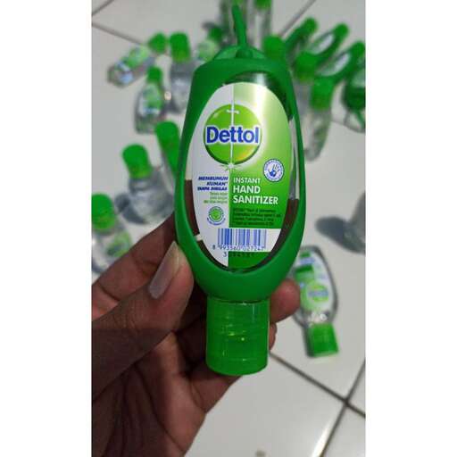 a bottle of shampoo is held in a hand.