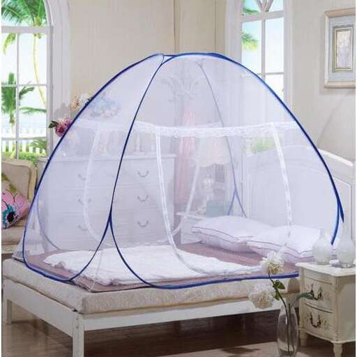 a tent made of a white bed and a white chair.
