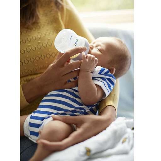 a baby drinking from a bottle.