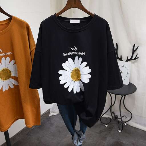 a black long sleeved shirt with a white flower on the front and a black and white flower on the front.