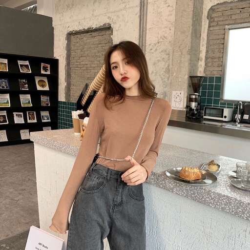 a woman is posing in a room with a table and a plate of food.
