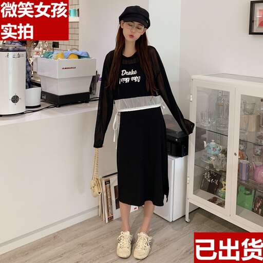 a woman in a black dress and a black hat.