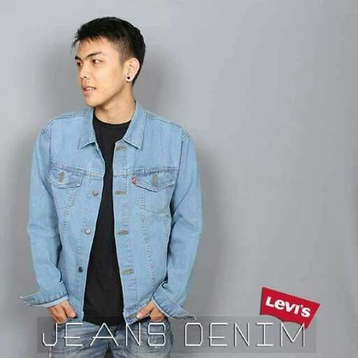 a man in a denim jacket and black shirt.