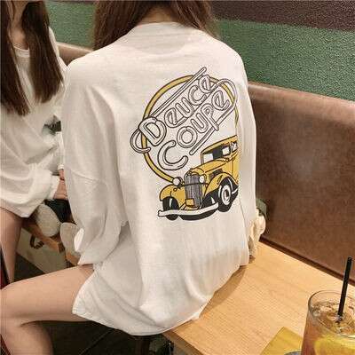 a girl sitting in a booth with a truck on her back.