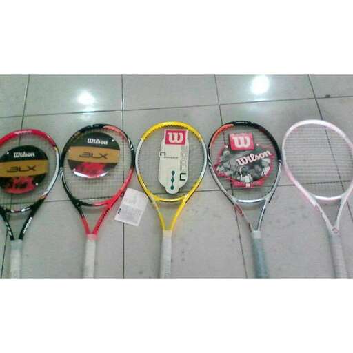 a group of tennis rackets sitting on a floor.
