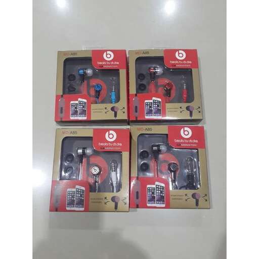 a group of four different types of earphones in a box.