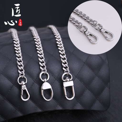 a black leather purse with a chain and chain