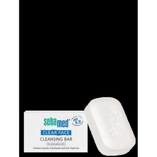 a white tube of toilet paper with a white toothbrush in the middle.