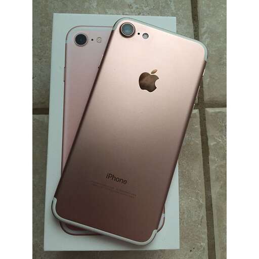 a pink iphone x sitting on a white box.
