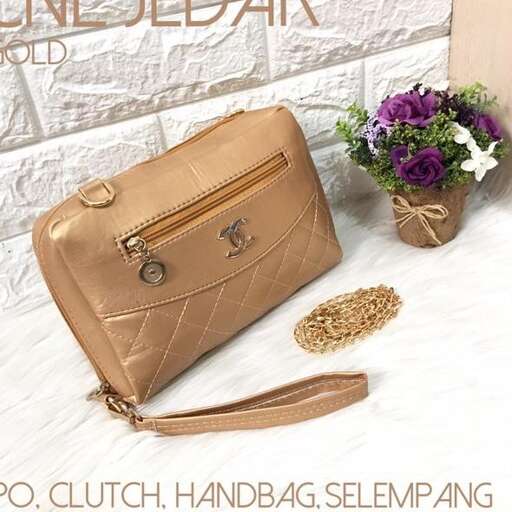 a purse with a flower in it and a flower pot on the side.
