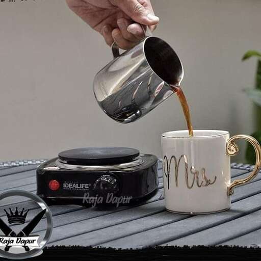 a person pouring coffee into a cup.
