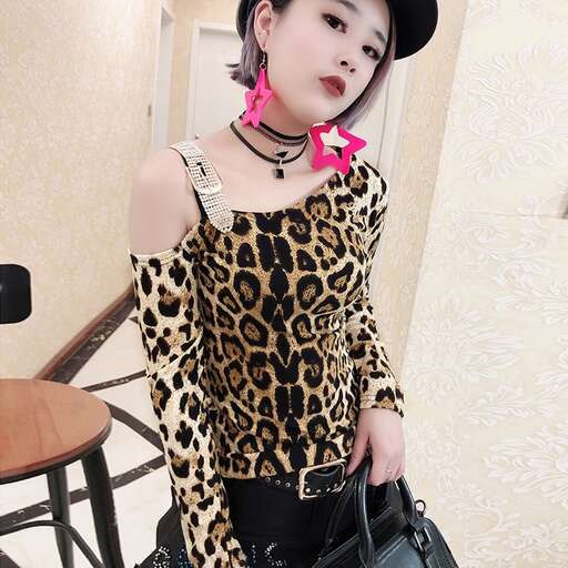 a girl in a leopard print dress and hat