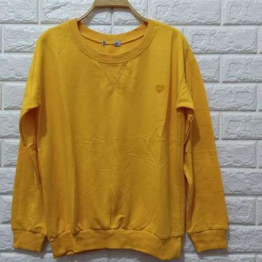 yellow sweater with a bird on the front