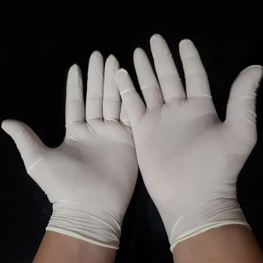 a pair of white gloves with a rubber glove on a black background.