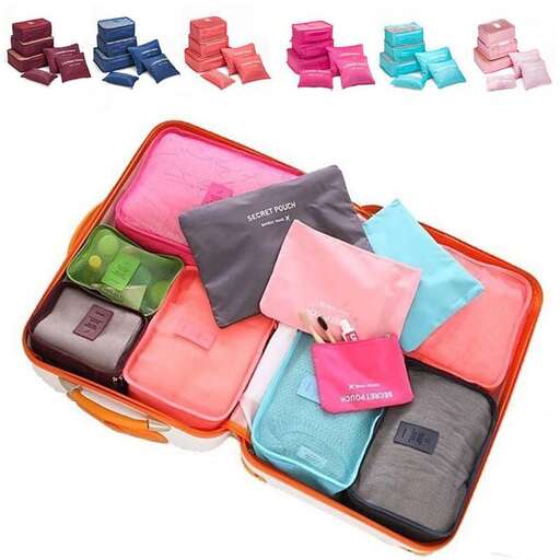 a suitcase filled with different colored clothing and accessories.