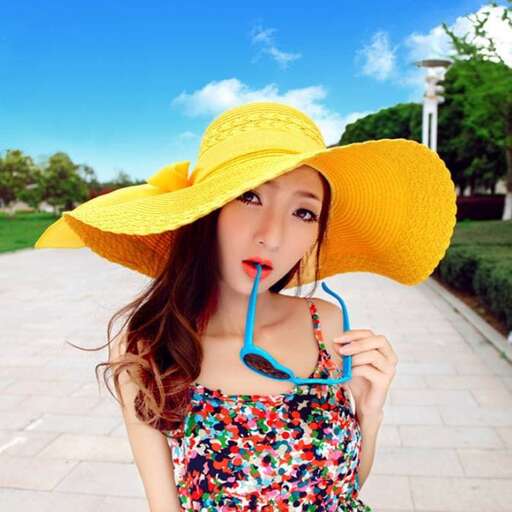 a woman in a yellow hat with a blue toothbrush