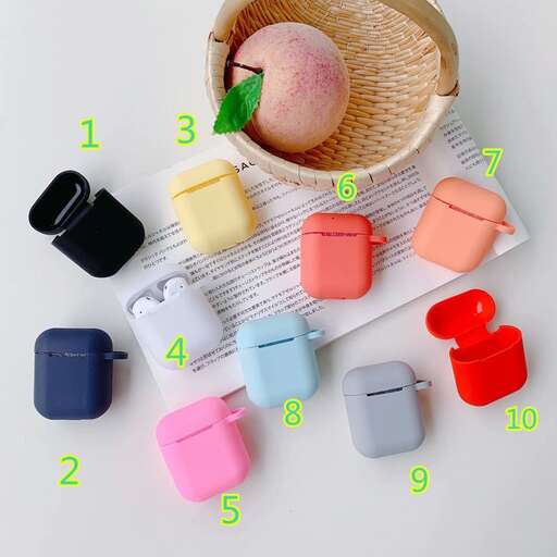 a basket of colorful plastic buttons and a small fruit in a straw hat.