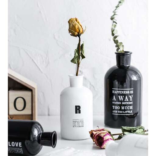 a vase with a single flower in it sitting on a table.