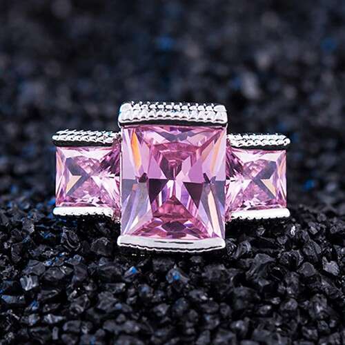 a pink sapphire and diamond ring set in 18k pink and purple.