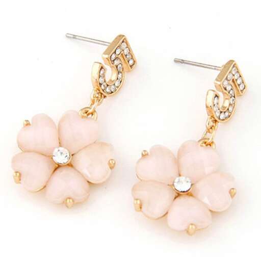 a pair of earrings with a flower design.