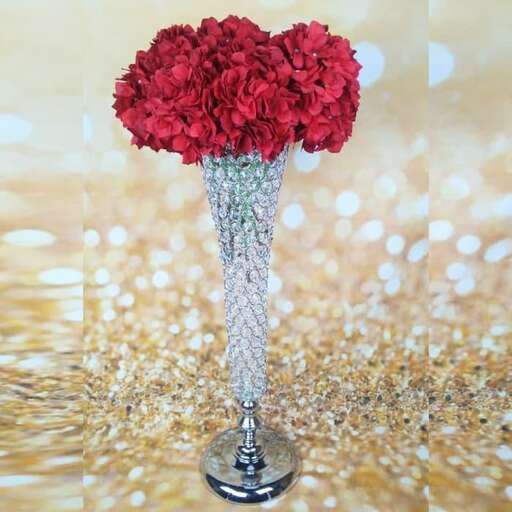 a vase with a bunch of red flowers in it