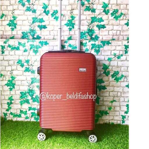 a suitcase sitting on top of a green grass covered field.
