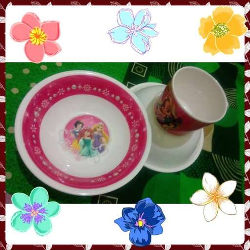 a plate with a cup of tea and a plate of flowers.
