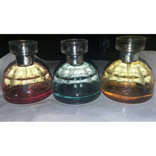 a set of three perfume bottles with colored glass.