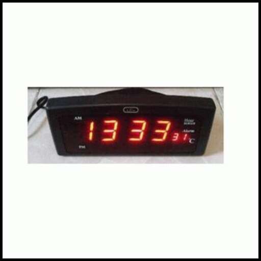 a digital clock with a digital time displayed on a wall.