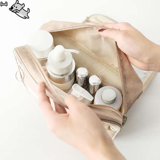 woman's hand holding a bottle of milk