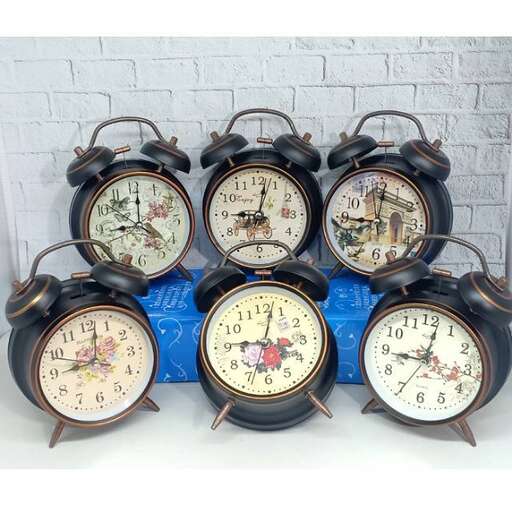 a group of four alarm clocks sitting on a table.