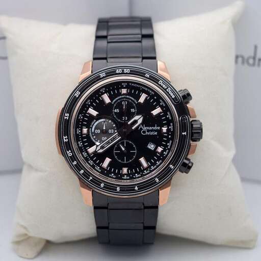 a watch with a black face and gold strap.