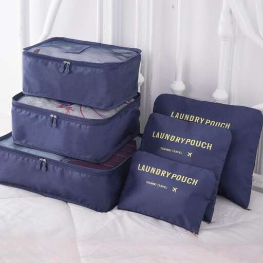 a stack of luggage sitting on top of a bed.