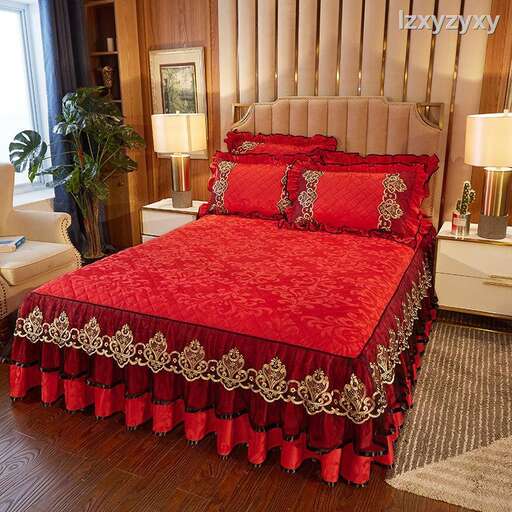 a red bed spread with a gold and white bed spread.